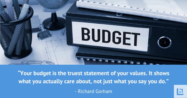 Your budget is the truest statement of your values Budget binder on a desk with the quote your budget is the truest statement of your values