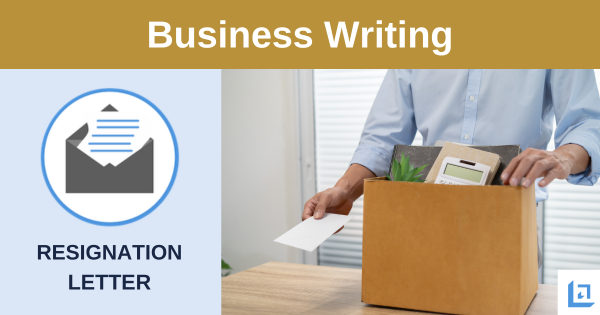 resignation letter beside a person packing a box of desk belongings
